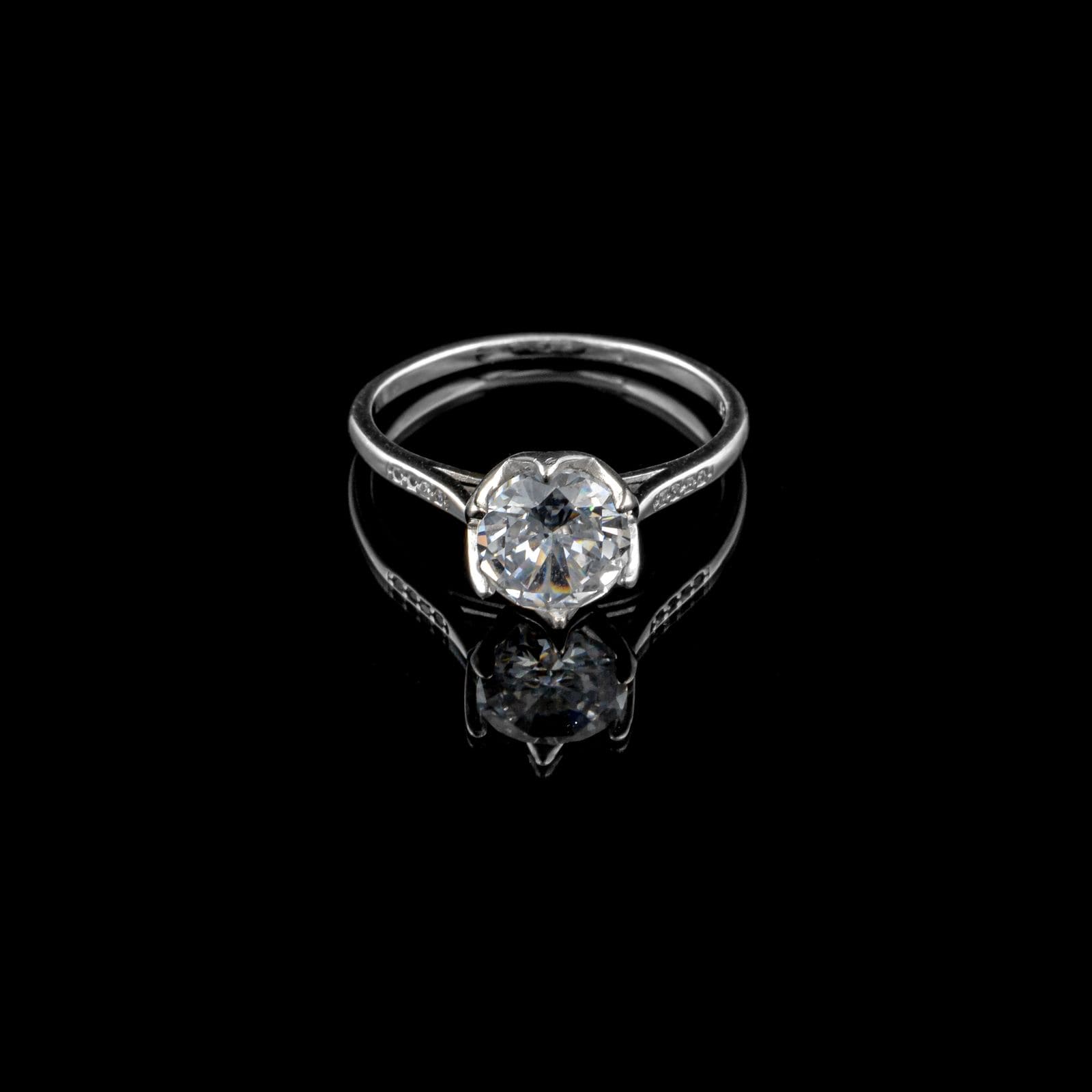 Men’s diamond ring on black glass