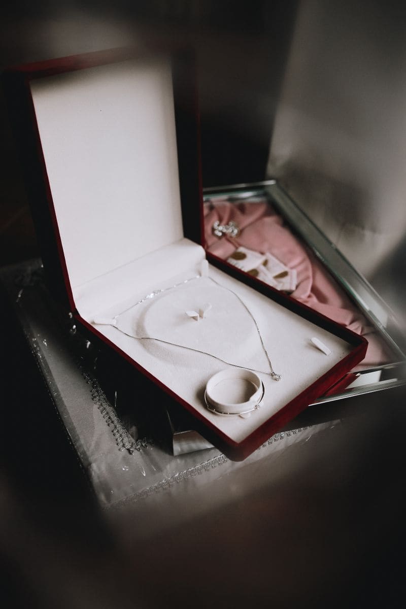 Open black jewelry box revealing a diamond necklace