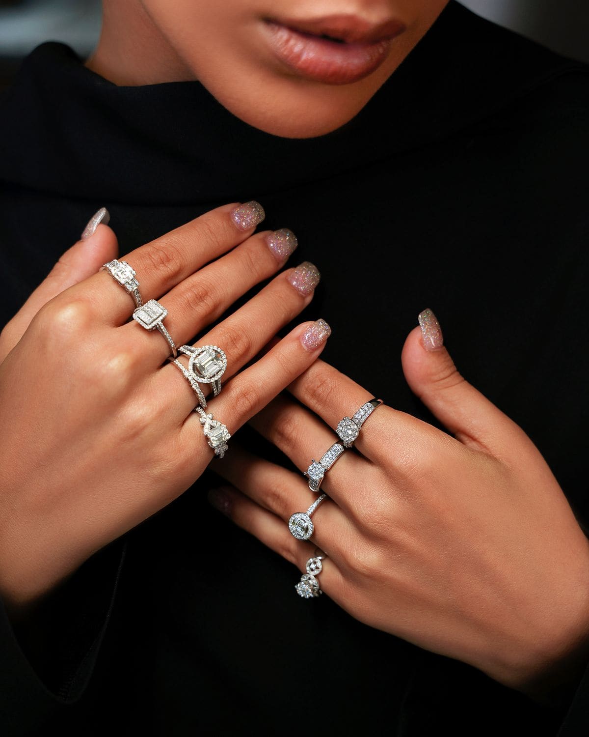Hands adorned with stacked diamond rings