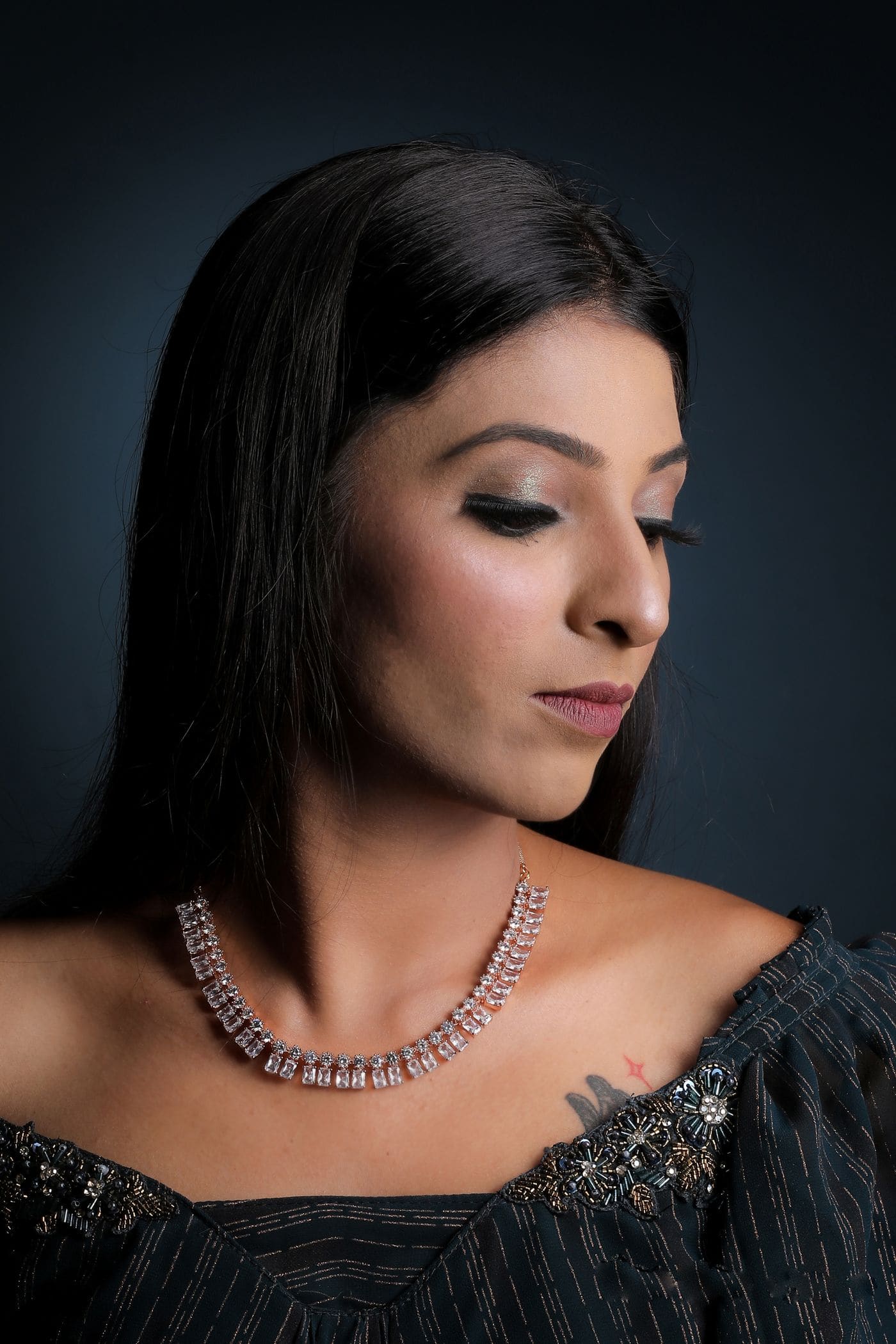 Model wearing diamond earrings and necklace