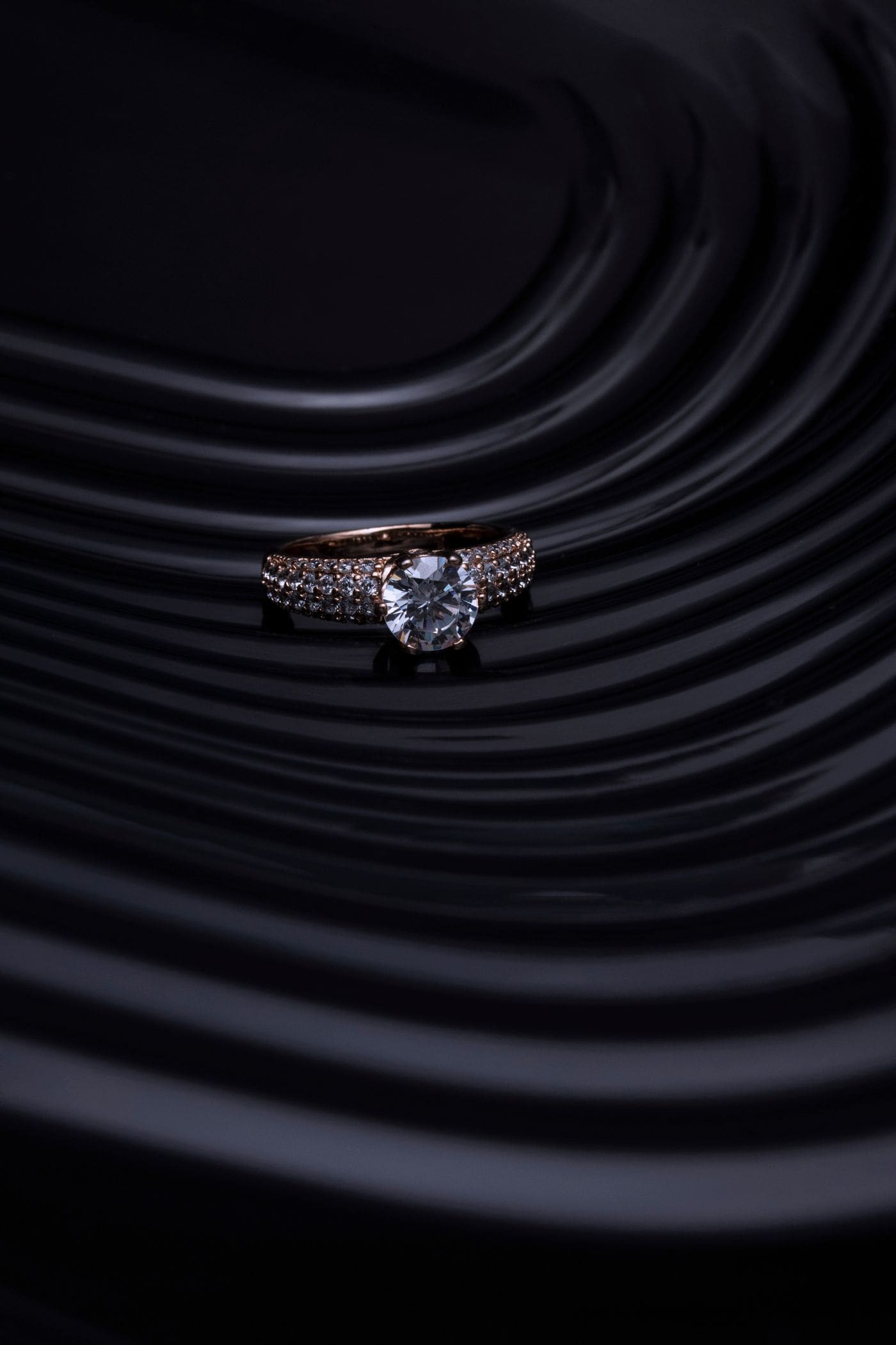 Close-up of a solitaire diamond ring under studio light