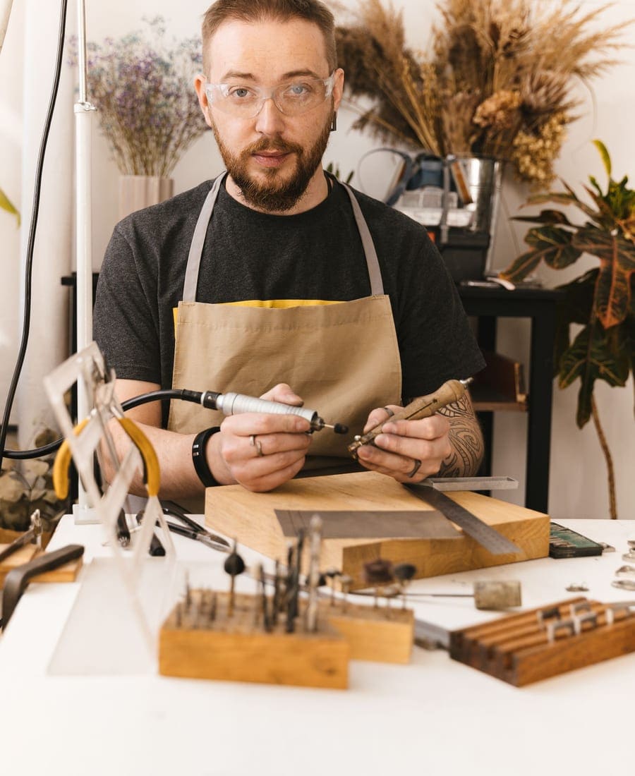 Jeweler’s hands shaping a gold ring at the workbench