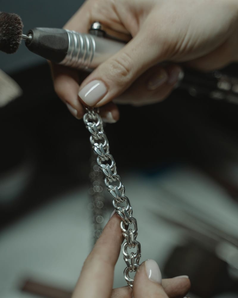 Diamond ring resting on a soft cloth beside a jewelry brush