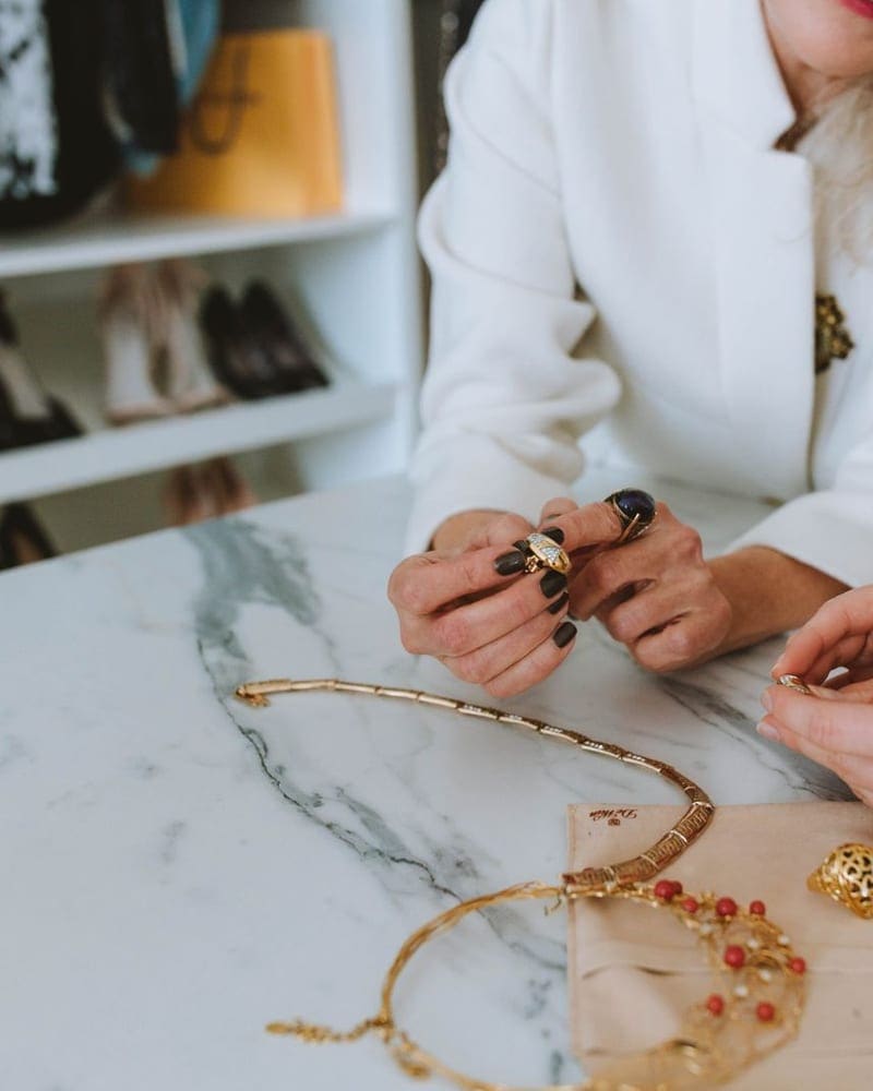 Hands gently polishing a diamond ring with a soft cloth