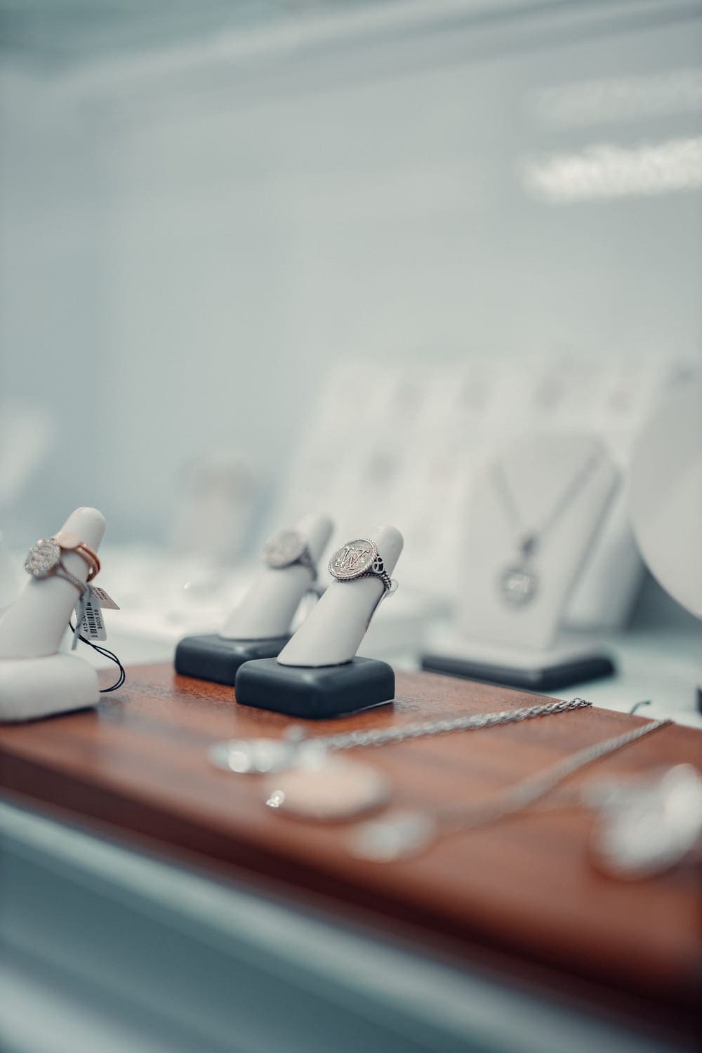 Diamond rings displayed on stands in a glass showcase