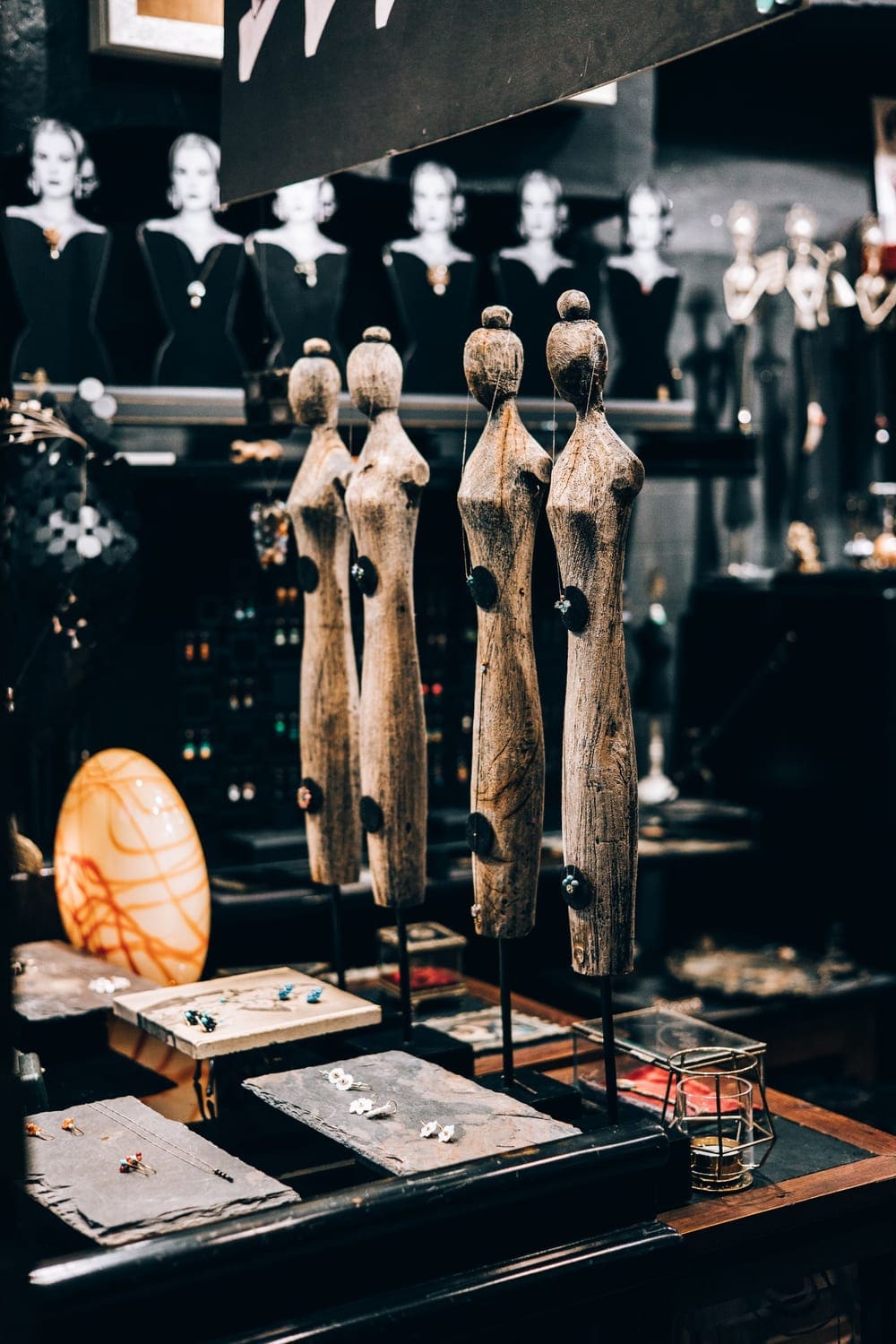 Sculptural display busts and jewelry trays in a dark boutique