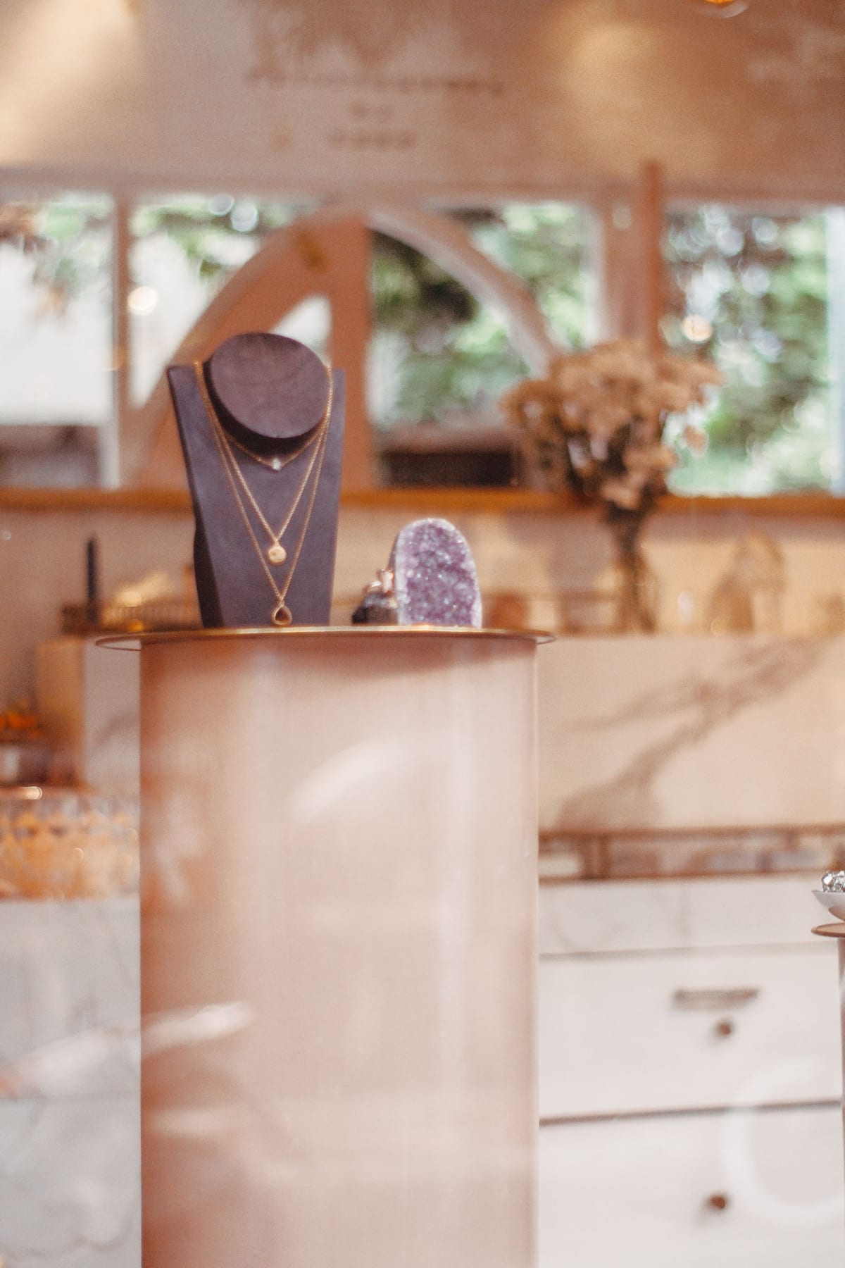 Diamond necklace on a velvet bust in a softly lit boutique